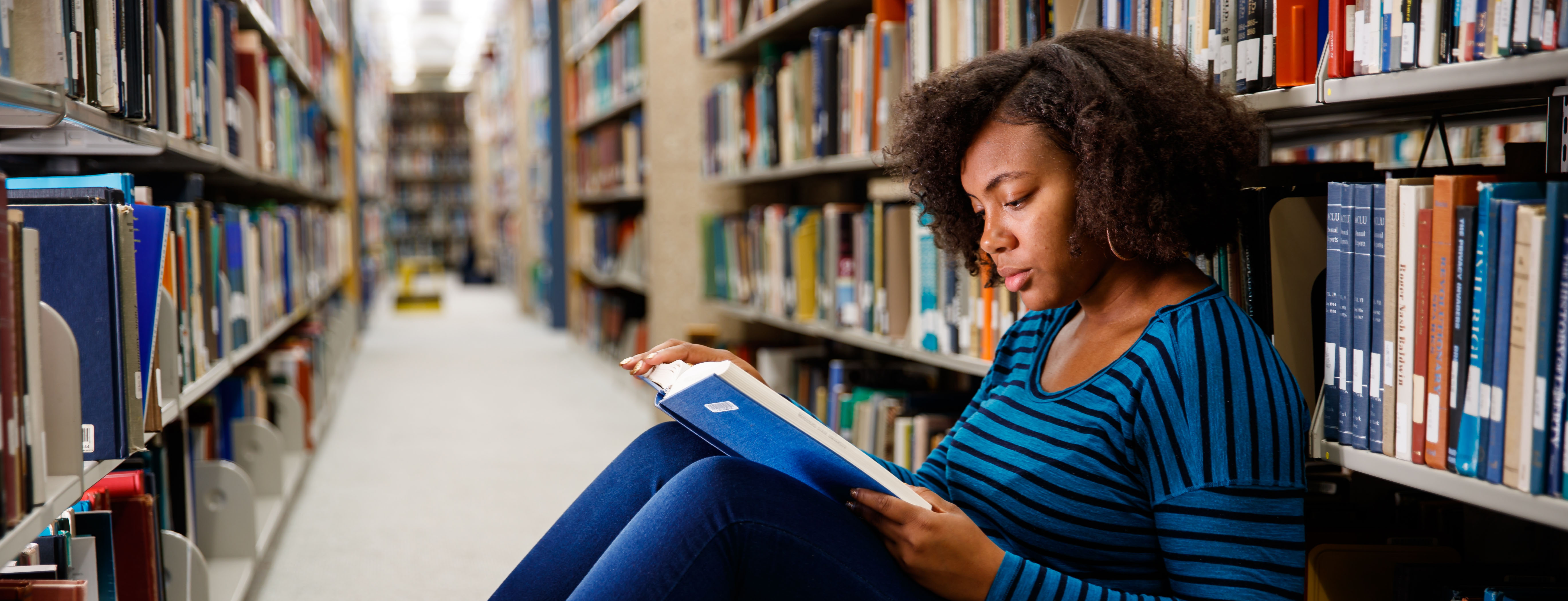 Female Student Reading in the Library