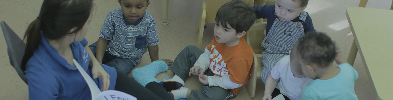 FDC staff member reading book to children