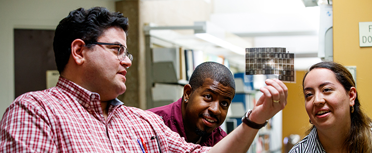 Professor showing students photo