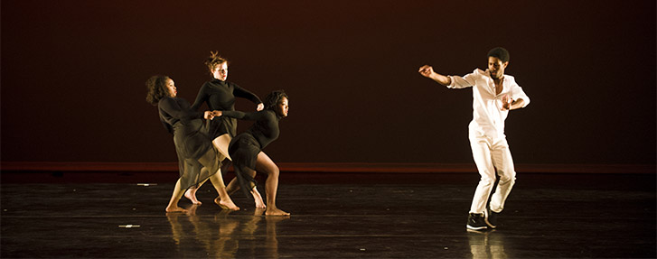 Dancers in black and white costumes
