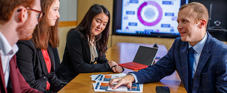 Professor showing students data