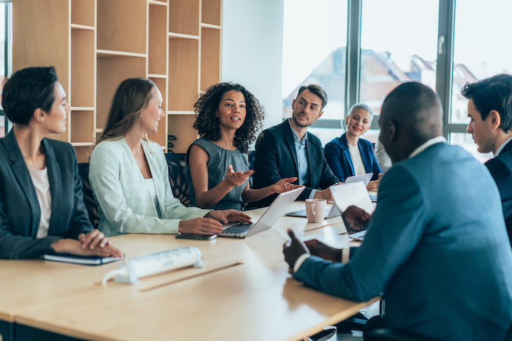 Group of people at table having a discussion