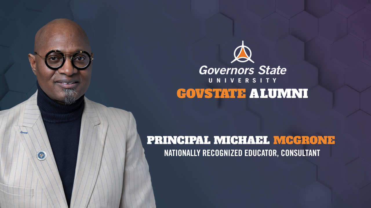 YouTube thumbnail for a Governors State University alumni interview featuring Principal Michael McGrone, Nationally Recognized Educator and Consultant. A smiling man wearing glasses and a light colored suit stands on the left against a dark blue hexagonal patterned background. The Governors State University logo and "GovState Alumni" appear at the top right, with Principal Michael McGrone's name and title displayed below in white and orange bold text.