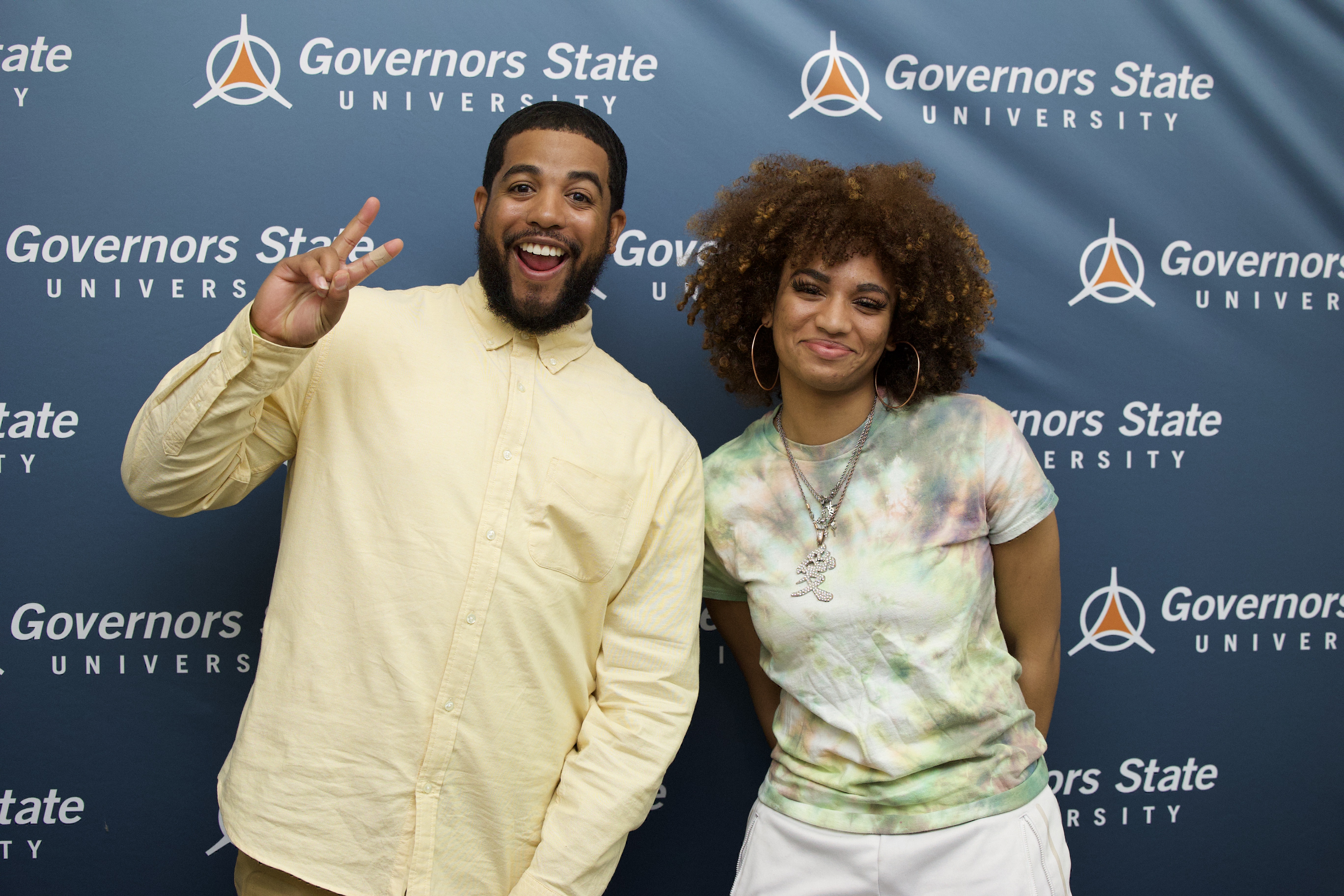 GovState alumnus, Jeremy Joyce smiling for a photo with a student during the Black History Education Symposium at Governors State University.