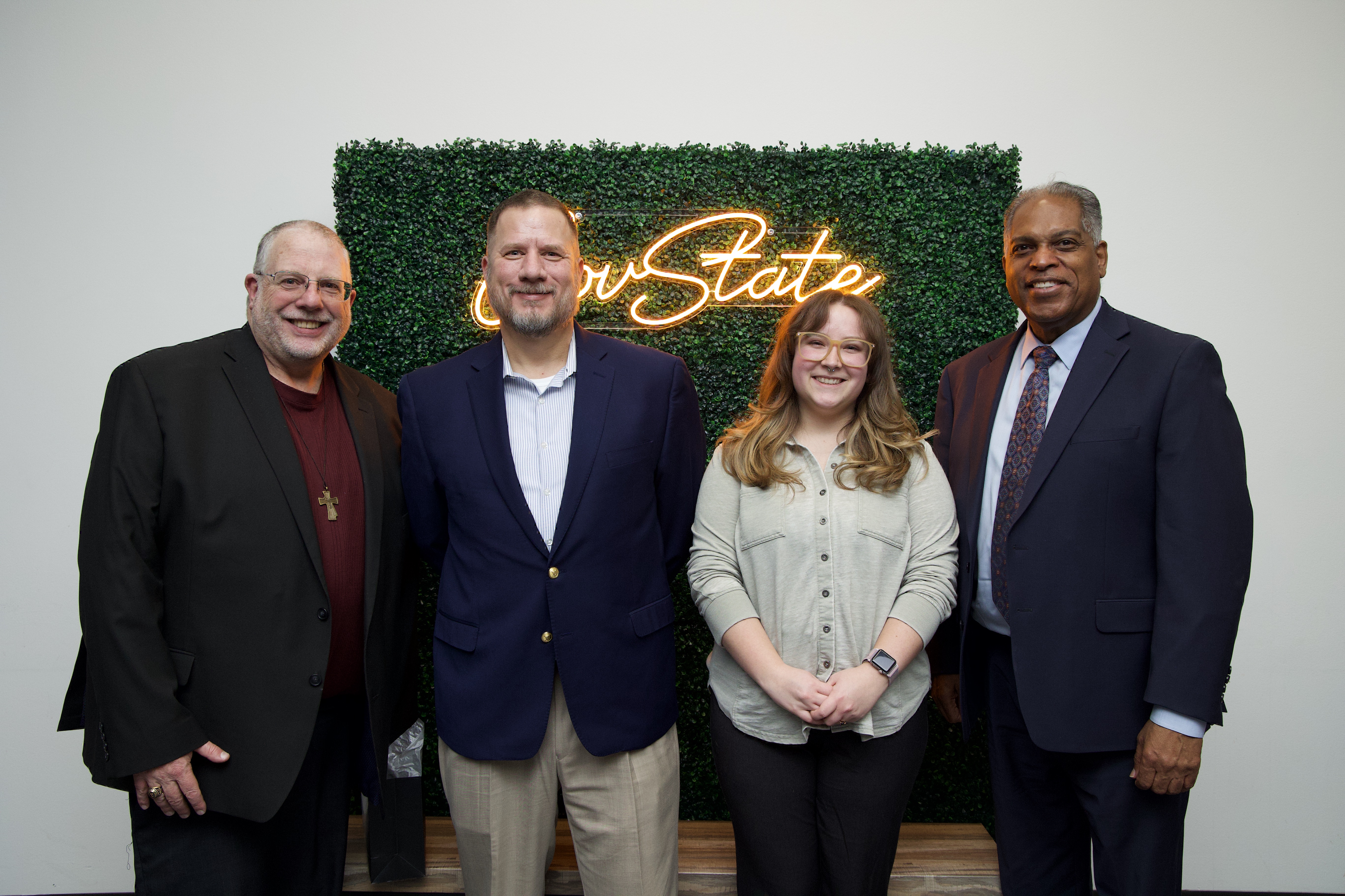 A group of professionals smiling for a photo during a chemistry networking event at Governors State University.