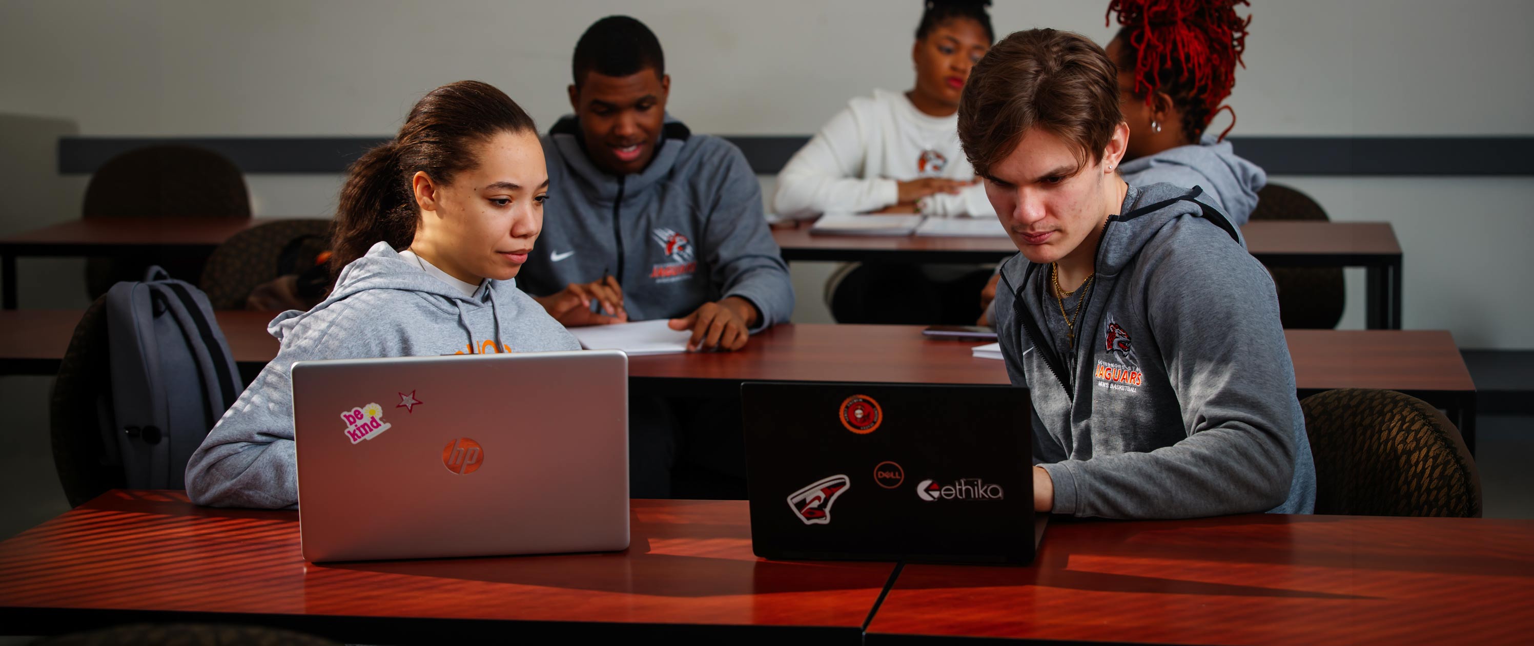 Students using laptops in a classroom