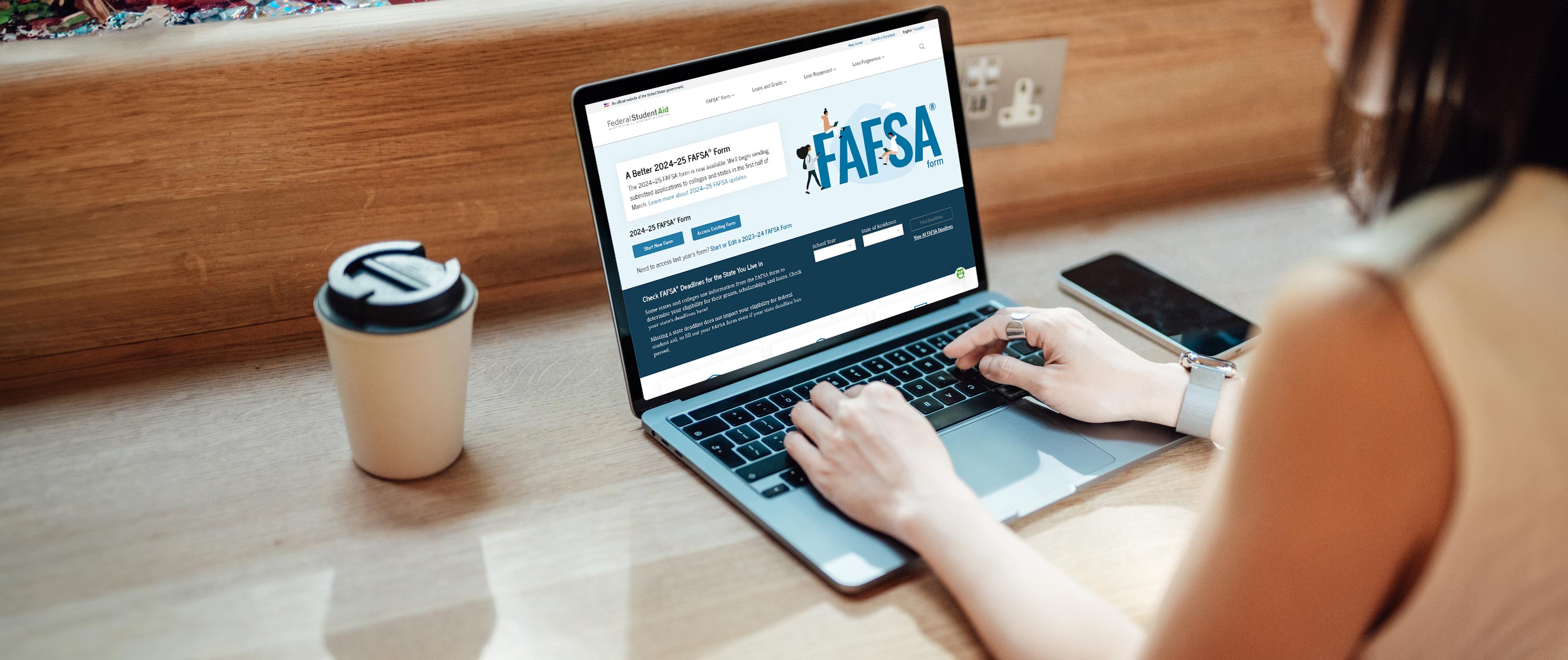 Person browsing FAFSA webpage on laptop